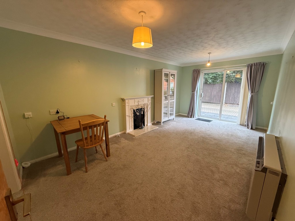 Lot: 73 - ONE-BEDROOM RETIREMENT FLAT - Carpeted lounge with French doors to courtyard